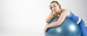 Frustrated woman on exercise ball